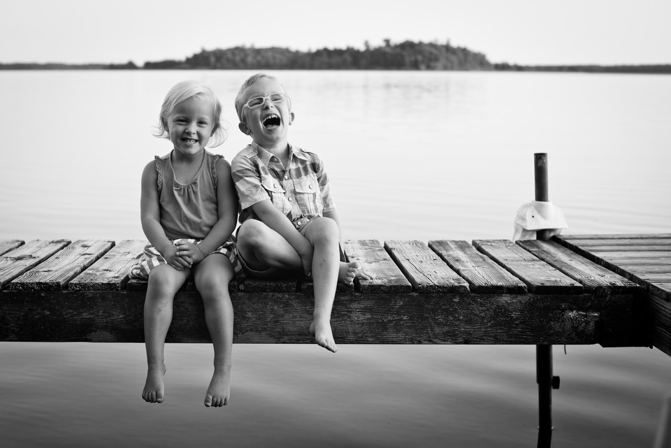 kids sitting on a dock