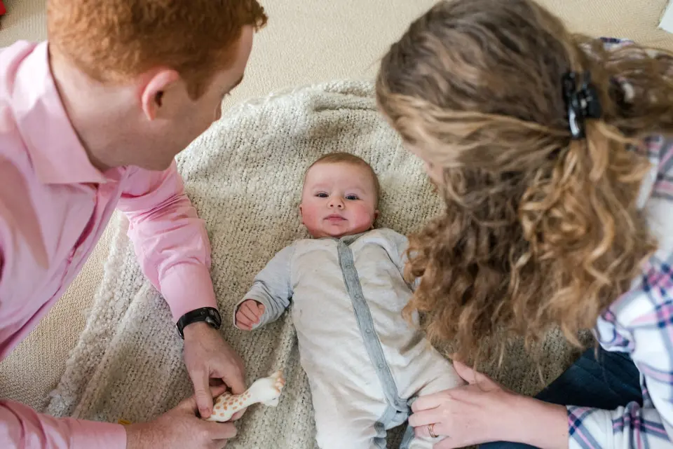 baby lays on carpet