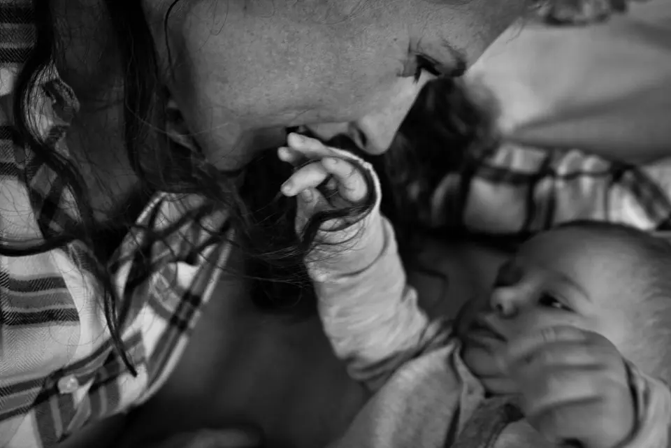 mom kisses baby's hand