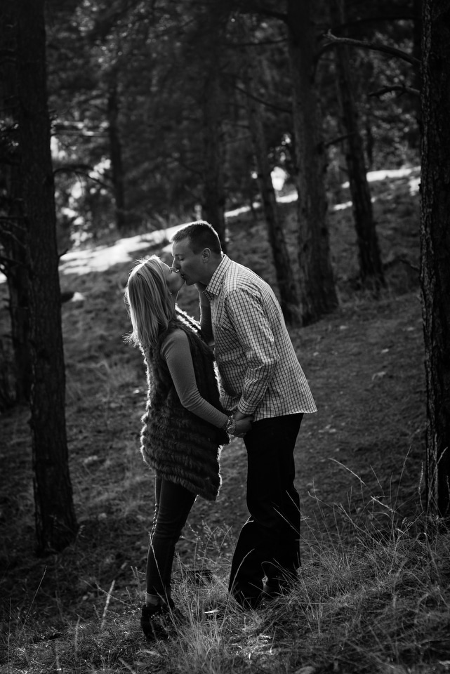 black and white kissing in woods