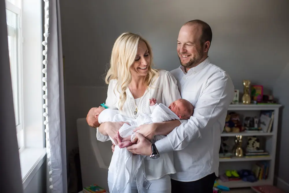 parents holding newborn twins