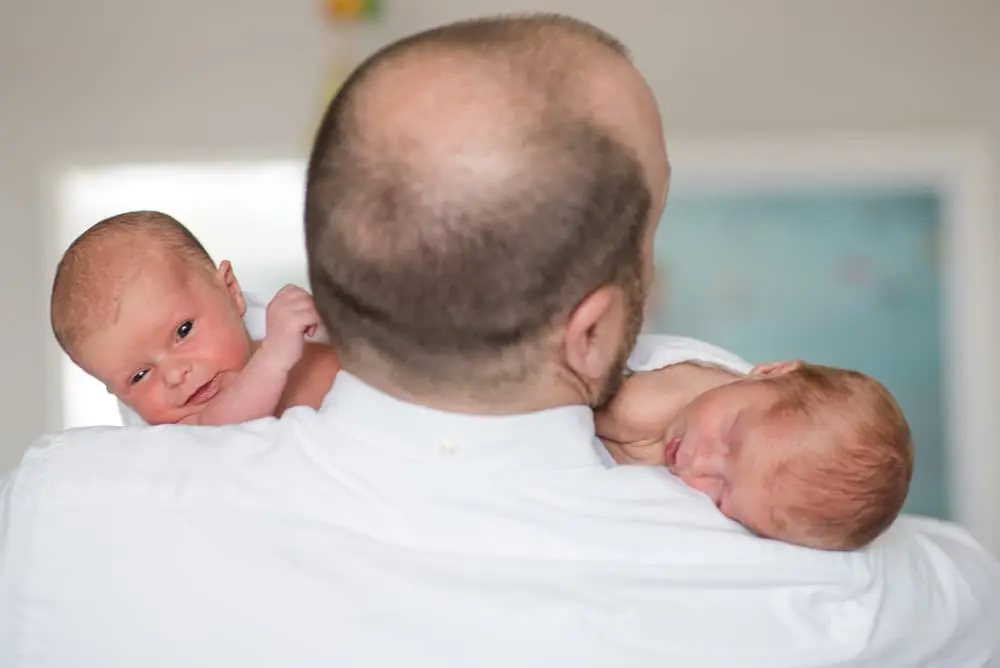 dad with newborn twin girls