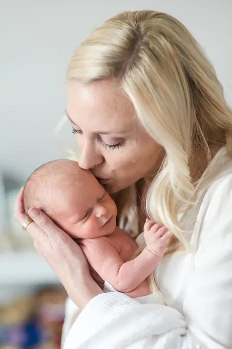 mom kissing baby