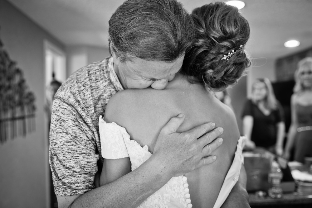 dad cries as he hugs bride
