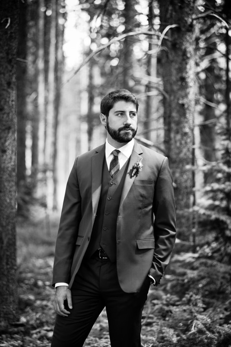 groom in woods in Breck