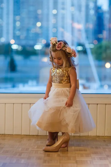 flower girl in bride's shoes