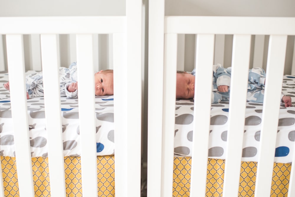 twin boys in two cribs