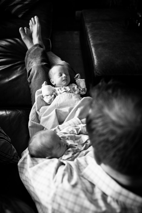 dad on couch with newborn twins