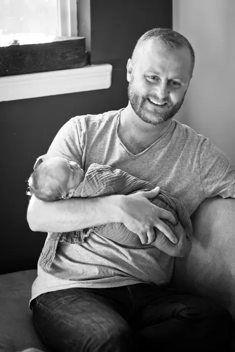 dad holds newborn baby