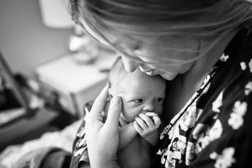 mom holds newborn baby