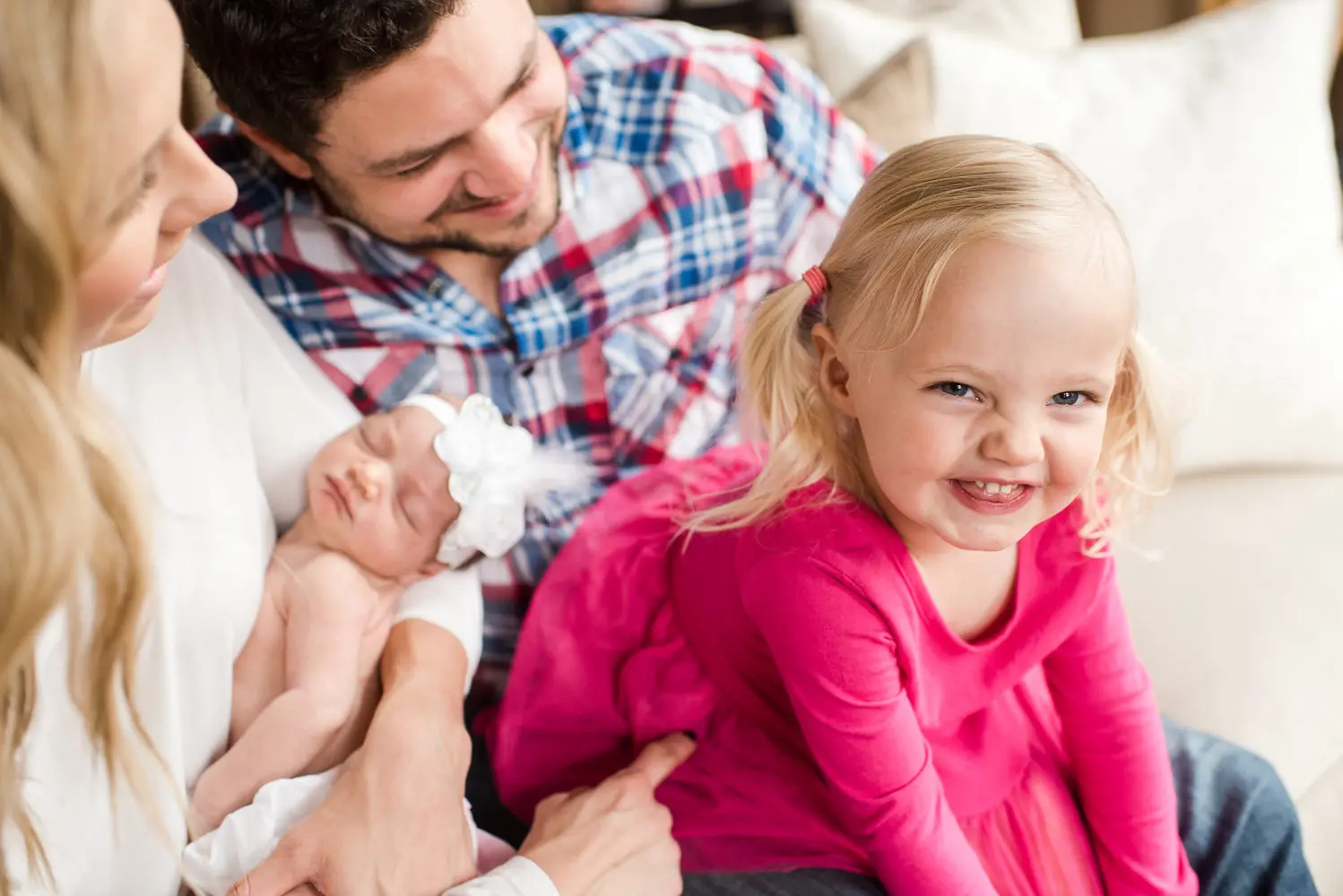 a girl smiles with her newborn portraits during their Denver newborn portraits