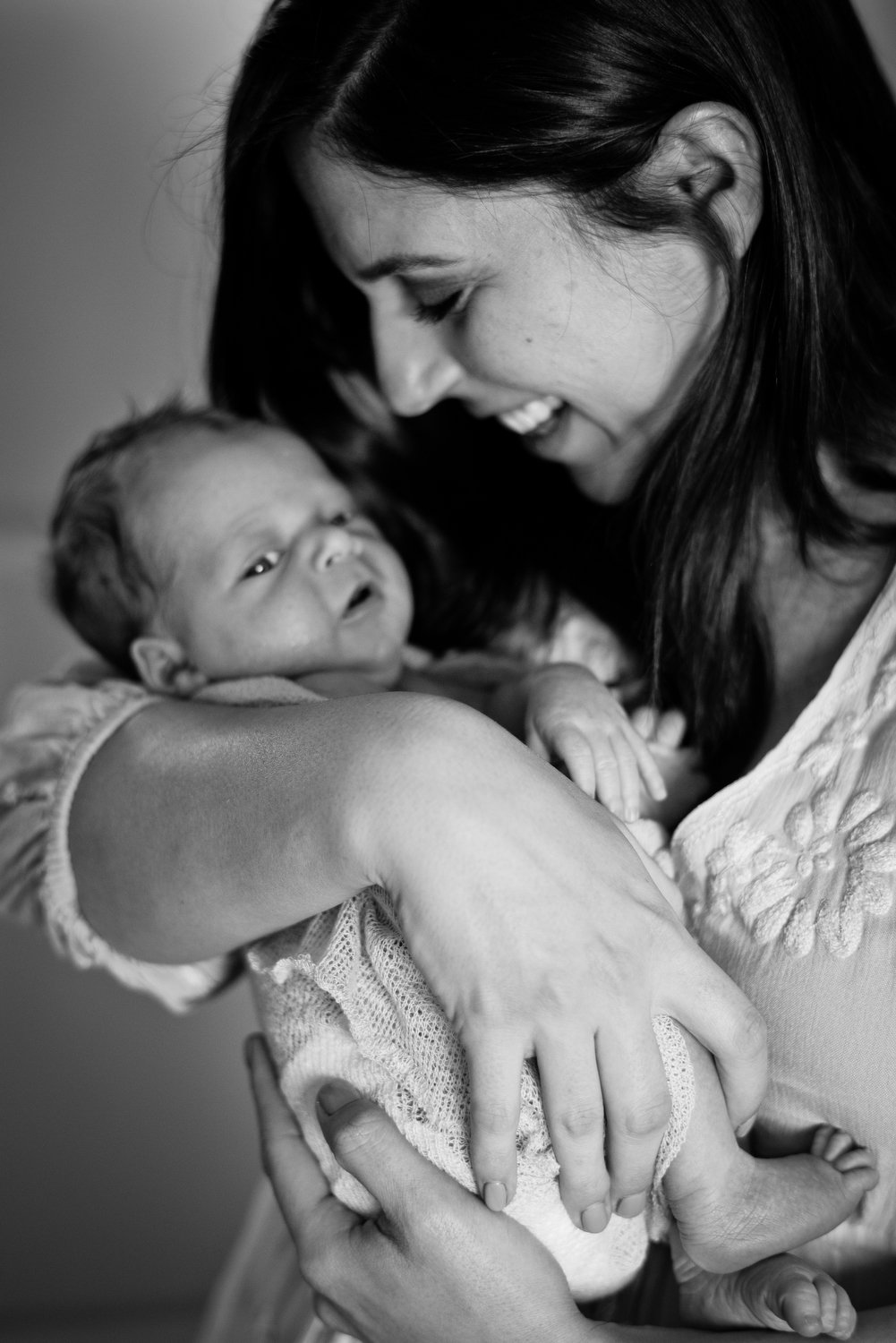 mom cuddles her newborn baby in Southmoor 
