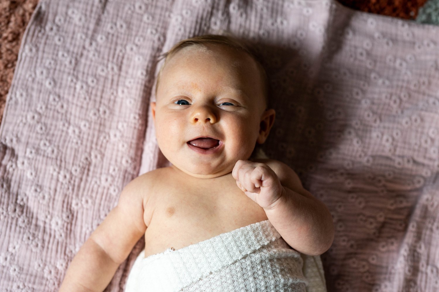 newborn baby girl smiles