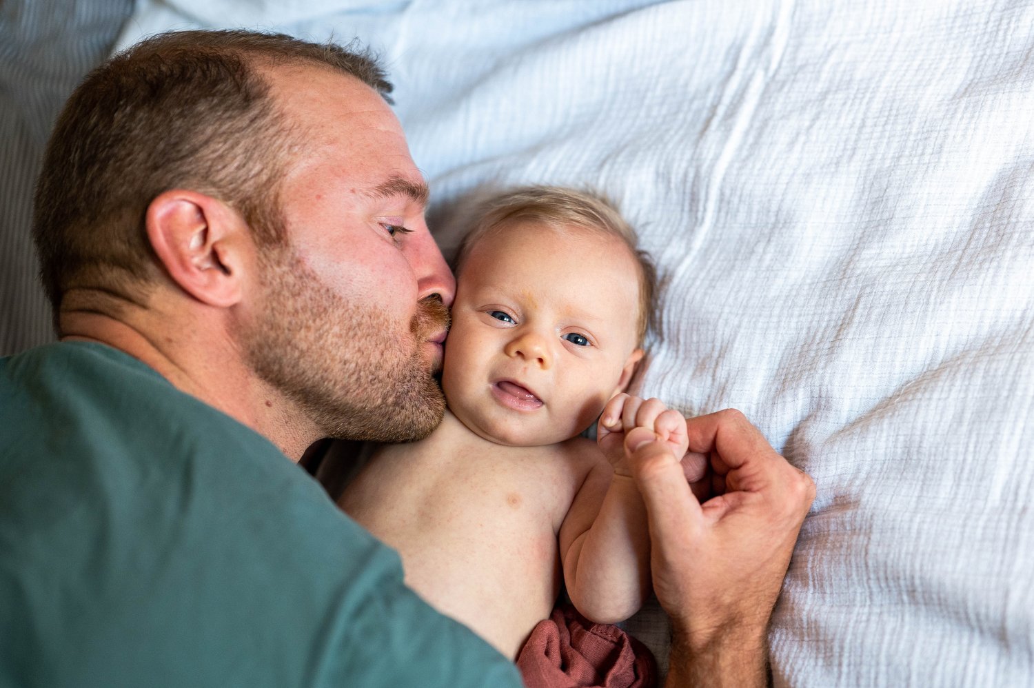 a dad kisses his baby girl in Denver