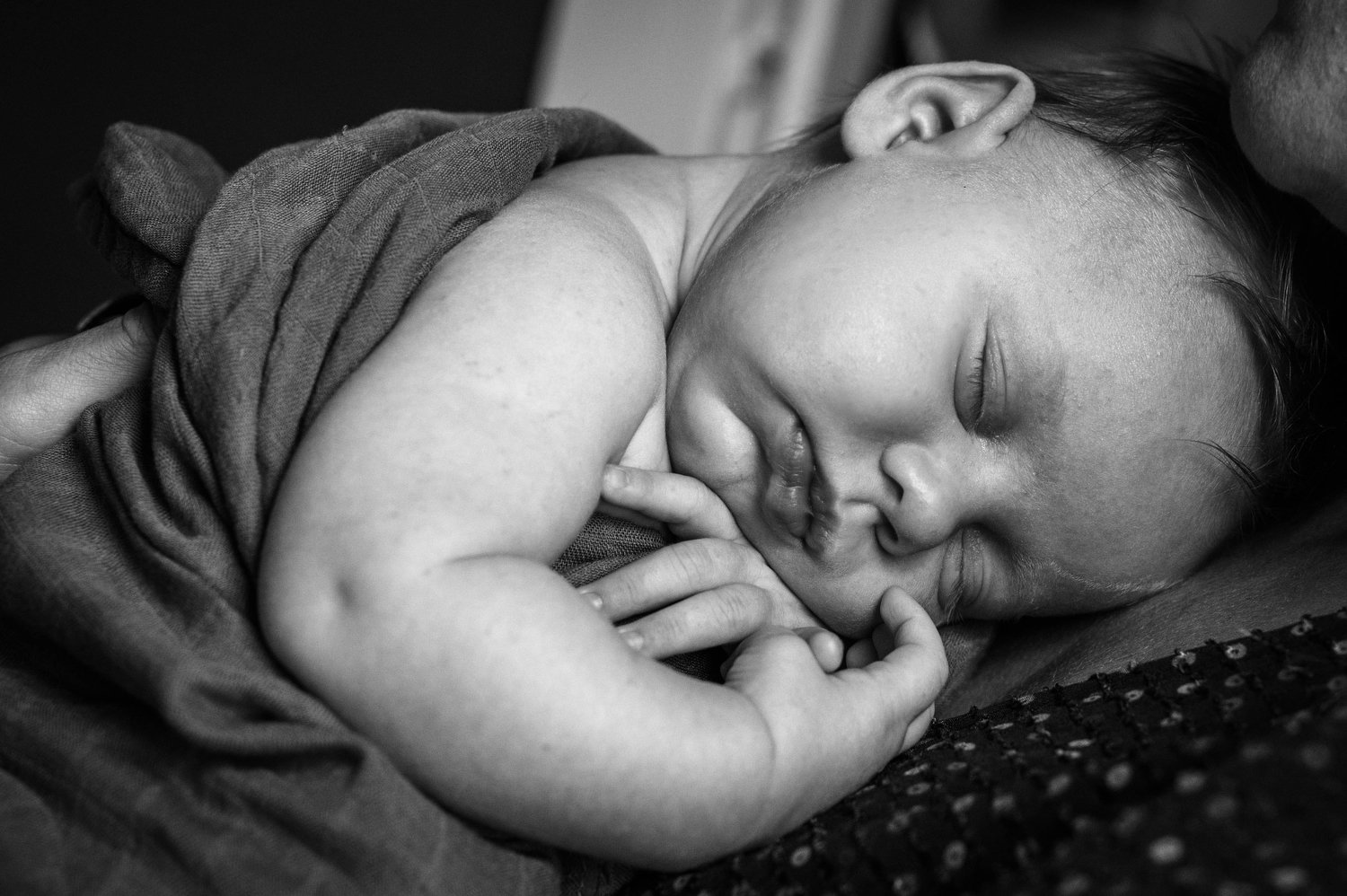 baby girl lays on her mom during newborn photos in Denver