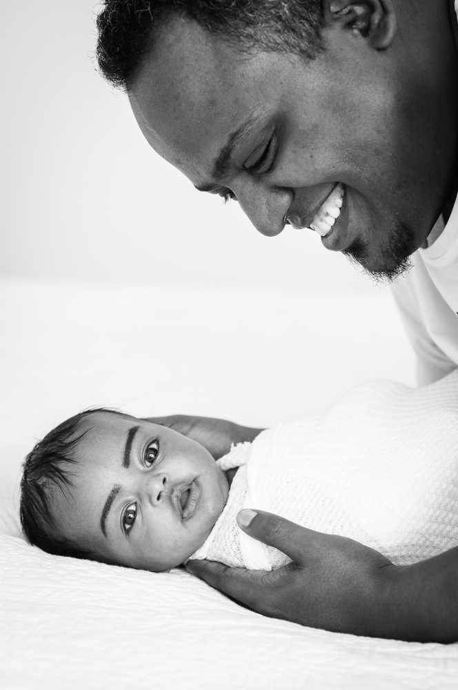 dad smiles at newborn