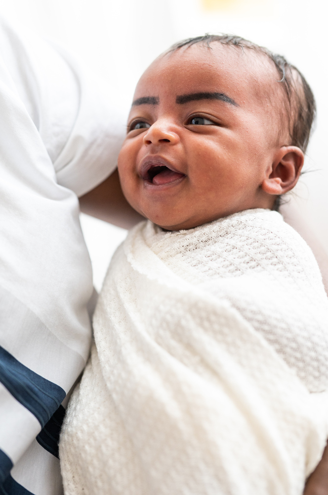 newborn baby smiles at dad