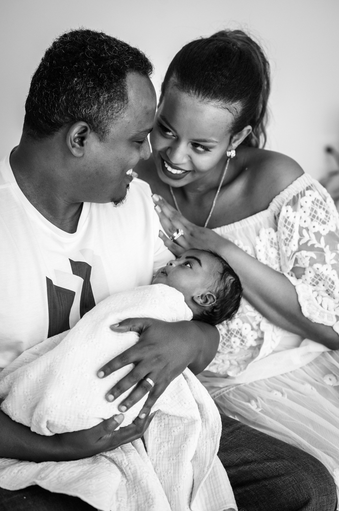 black and white family portrait with newborn baby