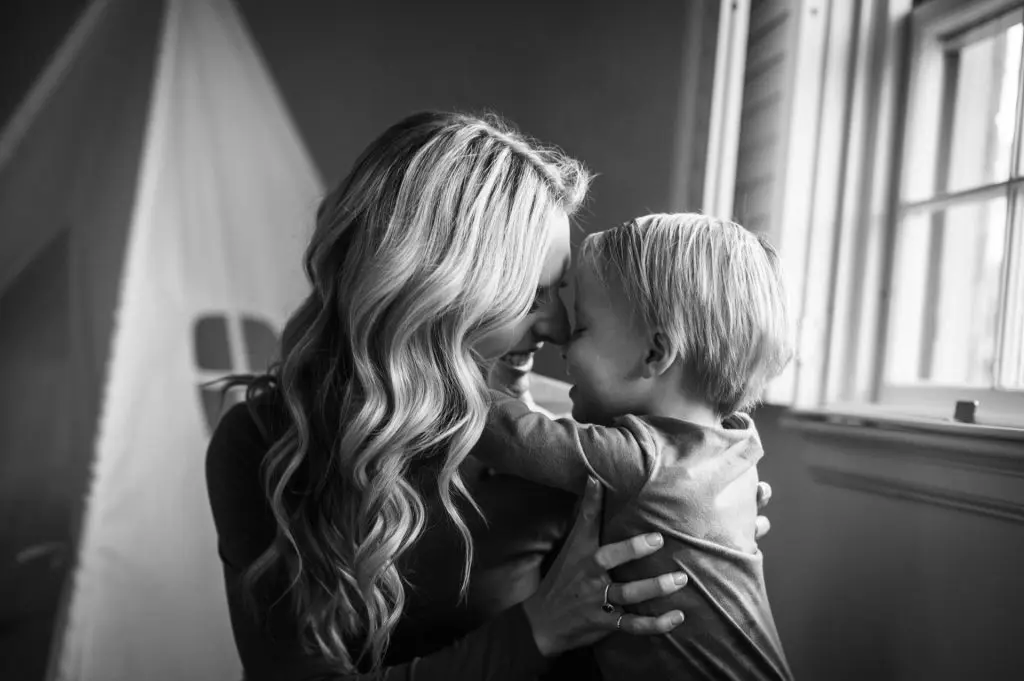 mom snuggles with son