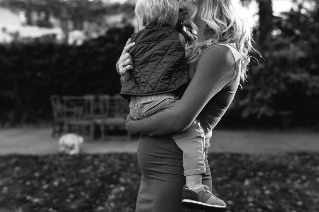 toddler sits on mom's belly in Denver