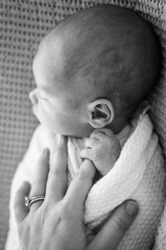 newborn holds mama's hand