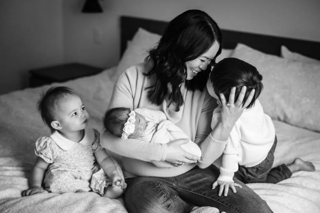 mom with babies at home on her bed in Englewood, CO
