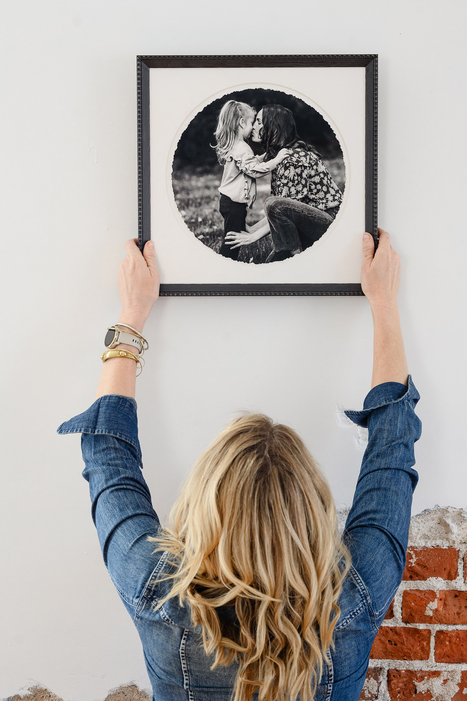 photographer holding framed photograph