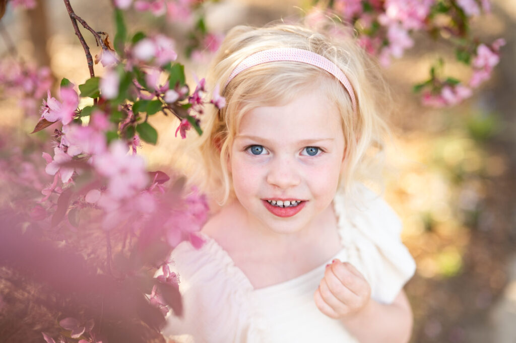 A girl poses among cherry blossoms in the spring in Denver.