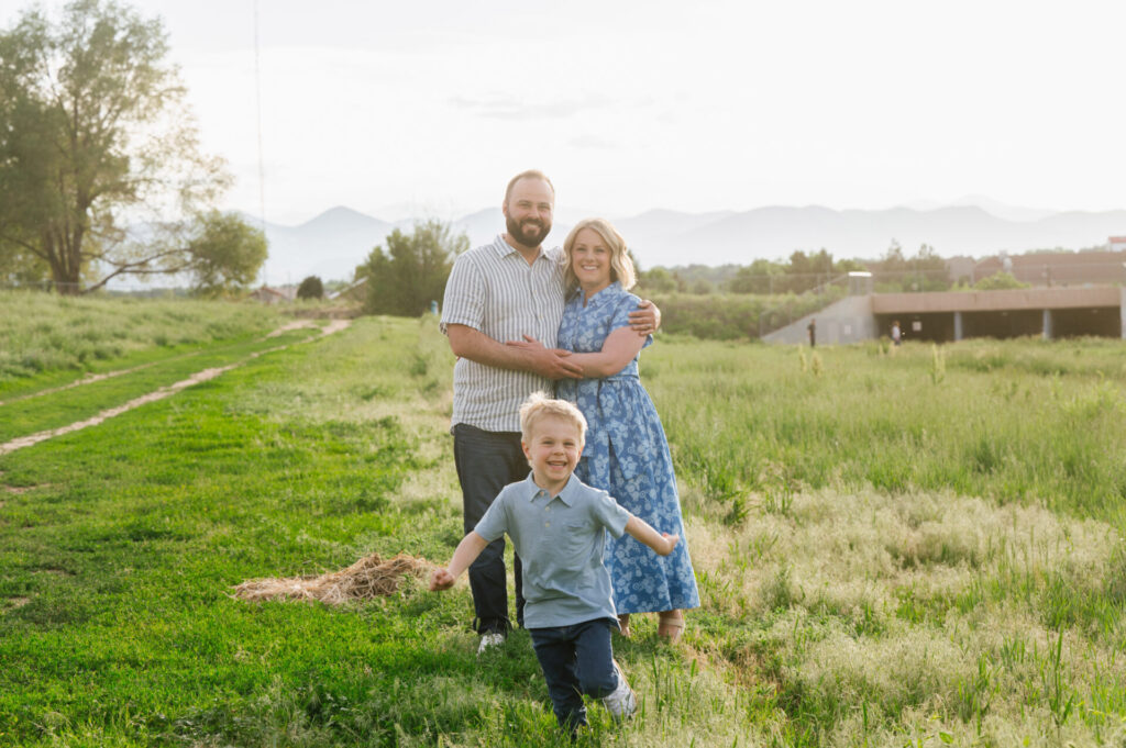 A boy runs around as his parents hug in Littleton.