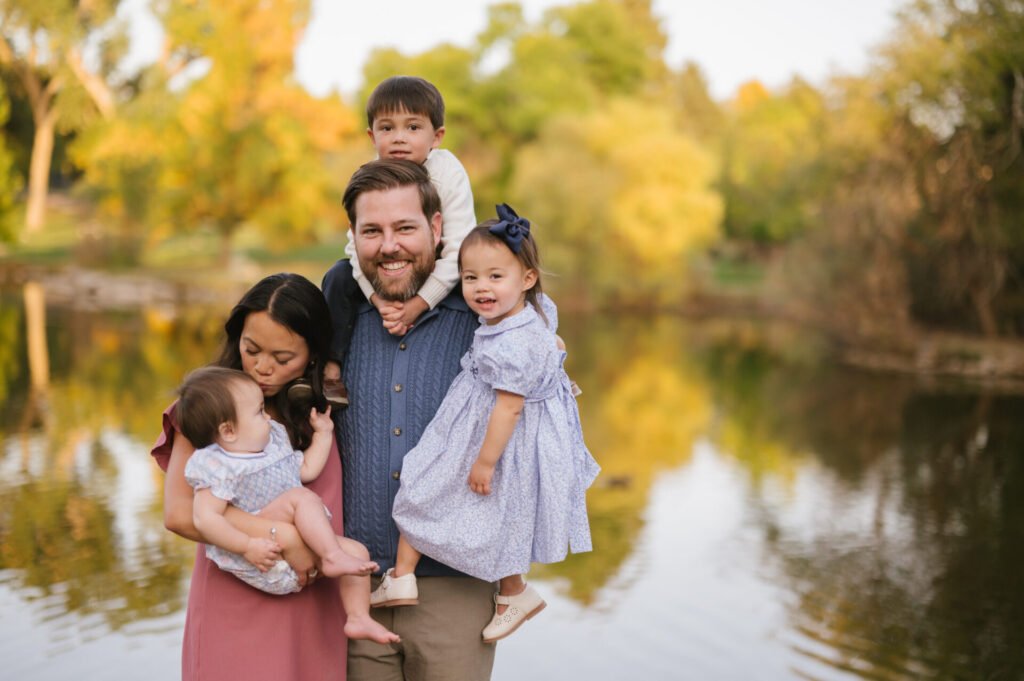 A family laughs during portraits in Littleton.